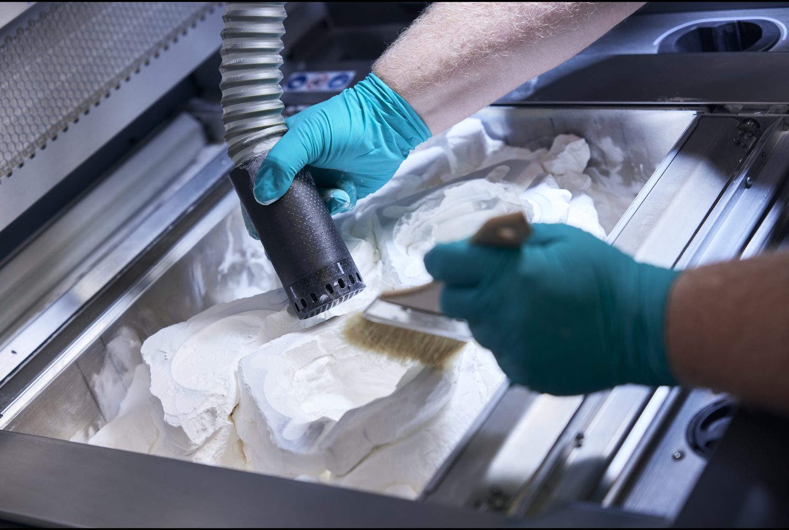 3D-Druck Entpulvern Entpulvern eines 3D-gedruckten Bauteils mit Pinsel und Absaugung